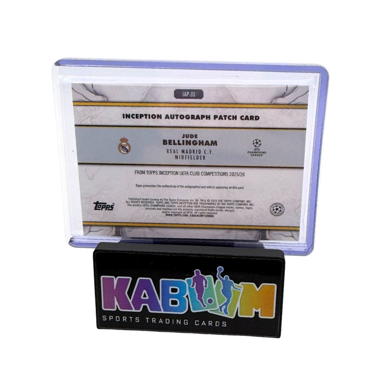 A collectible autograph patch card in a clear protective case mounted on a black display stand with the KABOOM logo. The card is for Jude Bellingham, Manchester City midfielder, from the 2024 Inception League Competition.