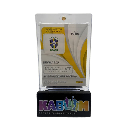 A collectible dual swatch autograph card of Neymar Jr. displayed in a clear plastic holder on a black stand.
