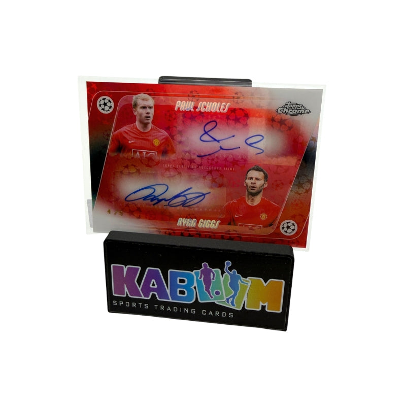 An autographed Paul Scholes and Ryan Giggs football trading card displayed on a black KABOOM sports trading cards stand against a white background.